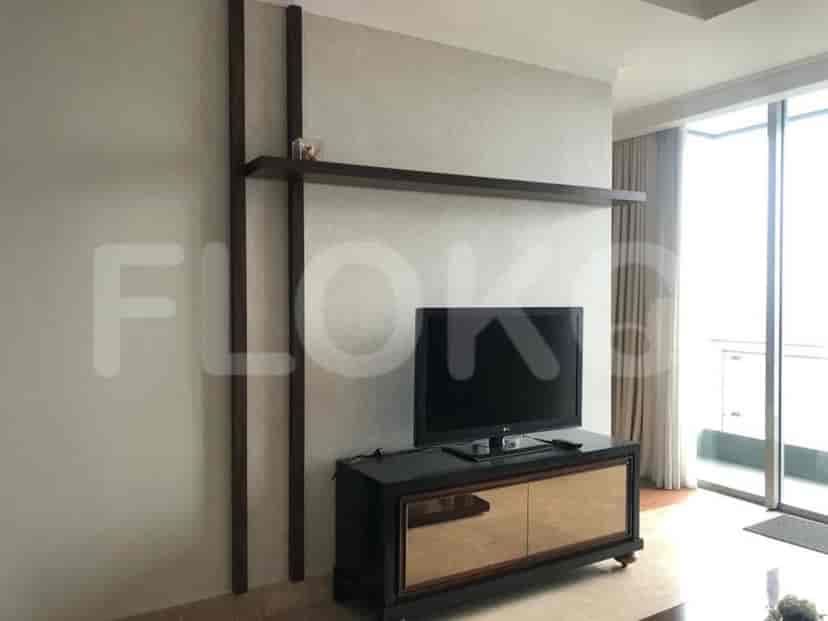 A living room with a TV and a cabinet.