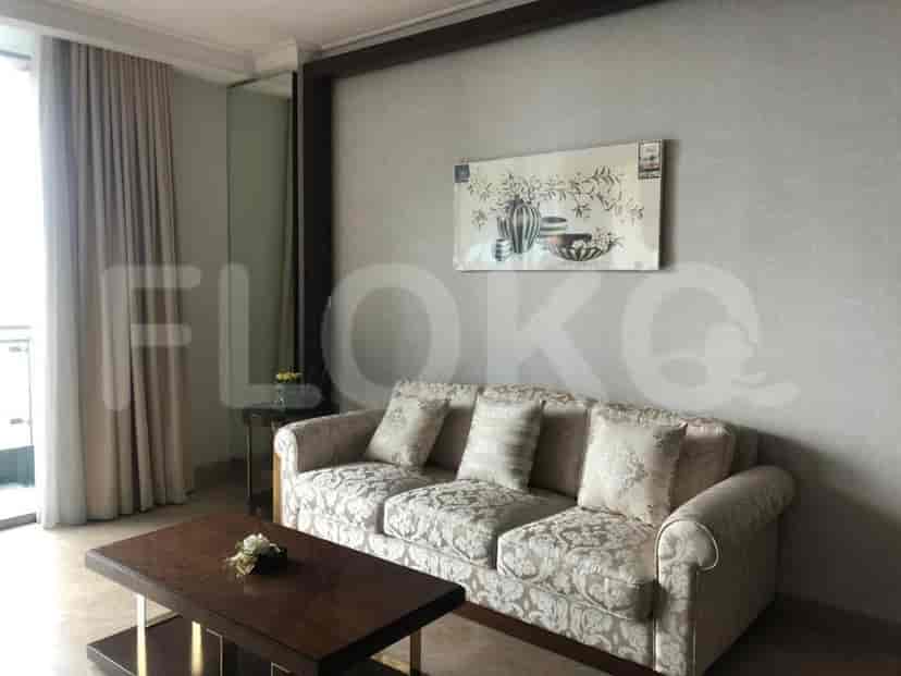 A living room with a sofa, coffee table, and wall art.