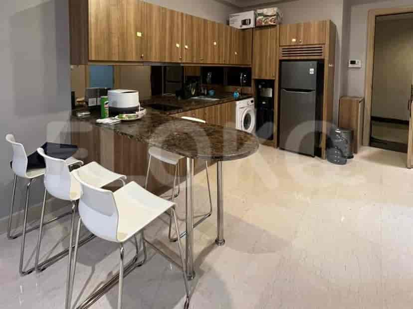 The kitchen features a modern design with white chairs and a dark countertop.