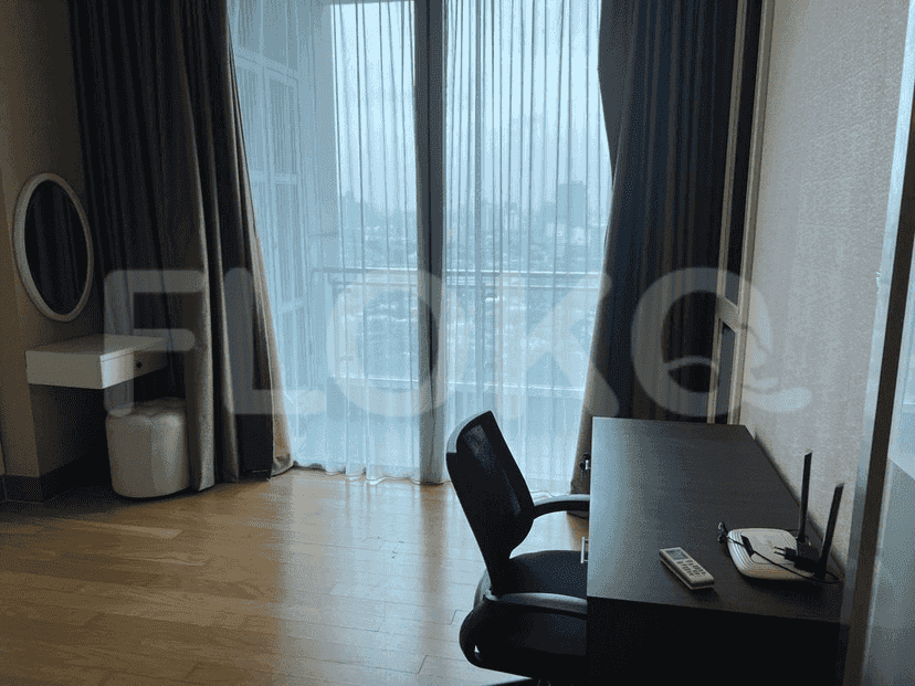 A study area with a desk, chair, and city view.