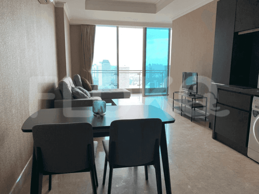 Living and dining space with a dark dining table, and a sofa set with a city view.