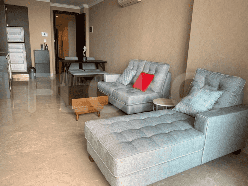 Living area featuring grey sofas and a coffee table, with a focus on seating and relaxation.