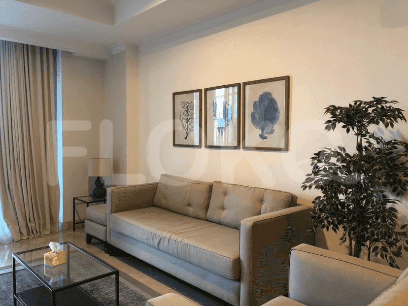 Living room with a sofa, wall art, and a glass coffee table.