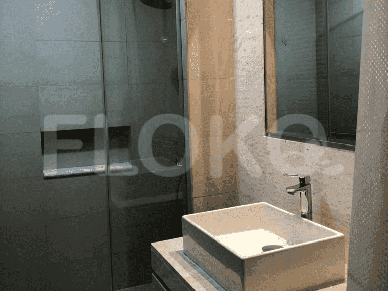 Modern bathroom featuring a square sink, shower, and a large mirror.