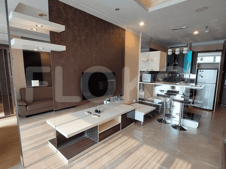 Spacious living area with open kitchen, bar seating, and integrated entertainment unit.