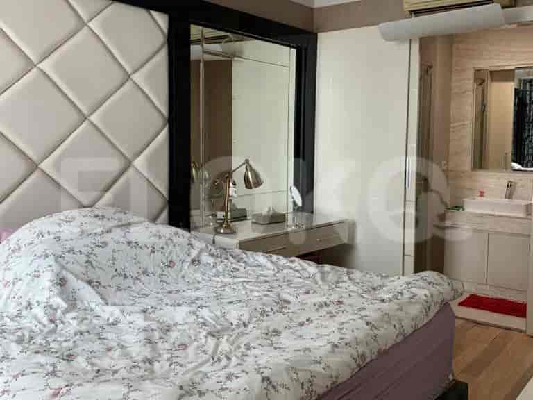 Bedroom with a large bed, vanity, and attached bathroom.
