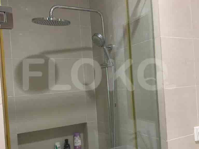 Modern bathroom with rain shower and glass enclosure.