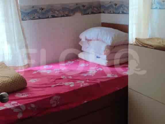 Bedroom with a bed, pillows, and a dresser.