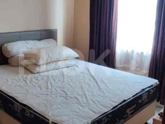 Bedroom with a bed, pillows, and curtains.
