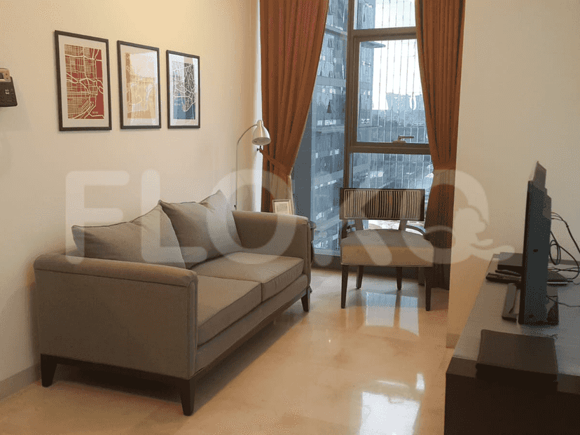 A modern living room with a grey sofa, artwork, and city view.