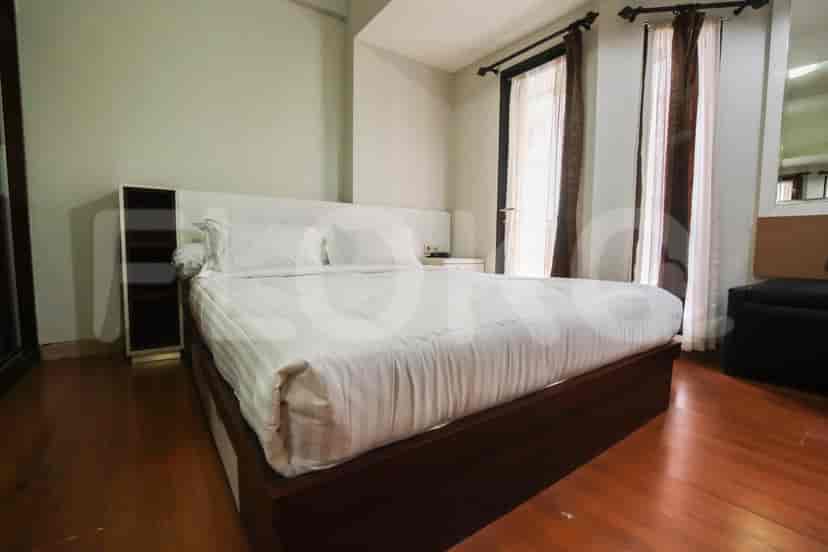 Another view of the bedroom with a king-size bed and access to a balcony.
