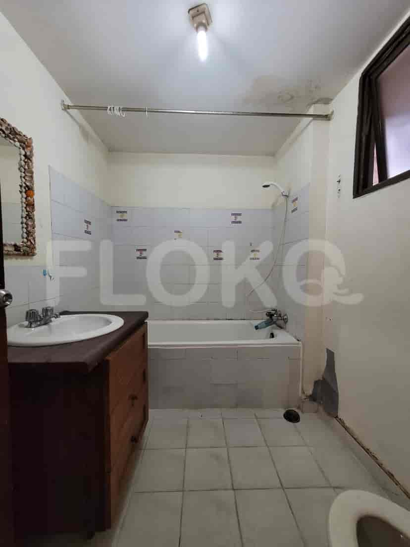 A small, simple bathroom with a bathtub, sink, and toilet.