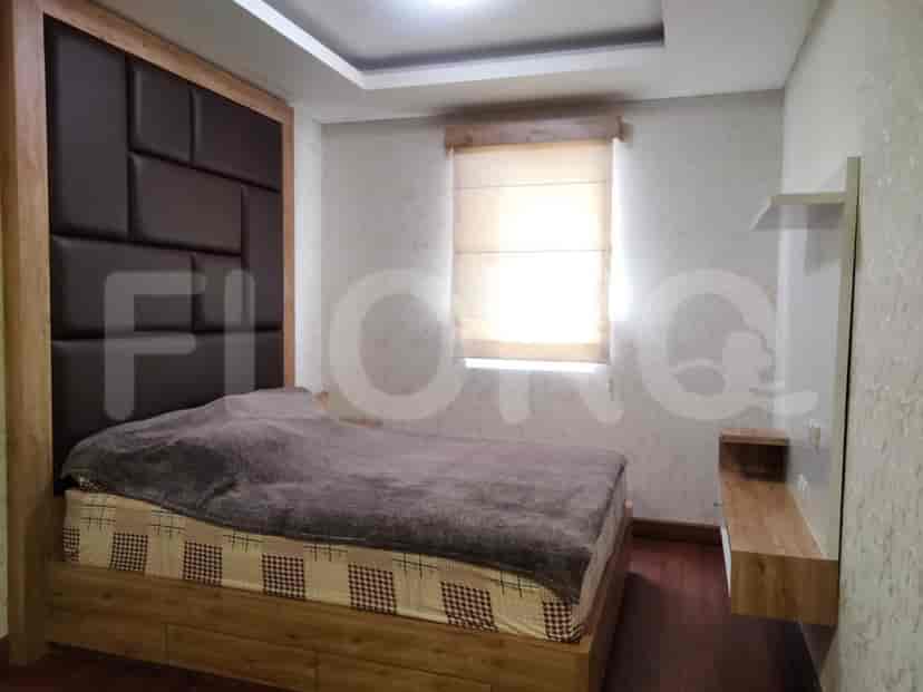 A bedroom with a bed and wooden accents.