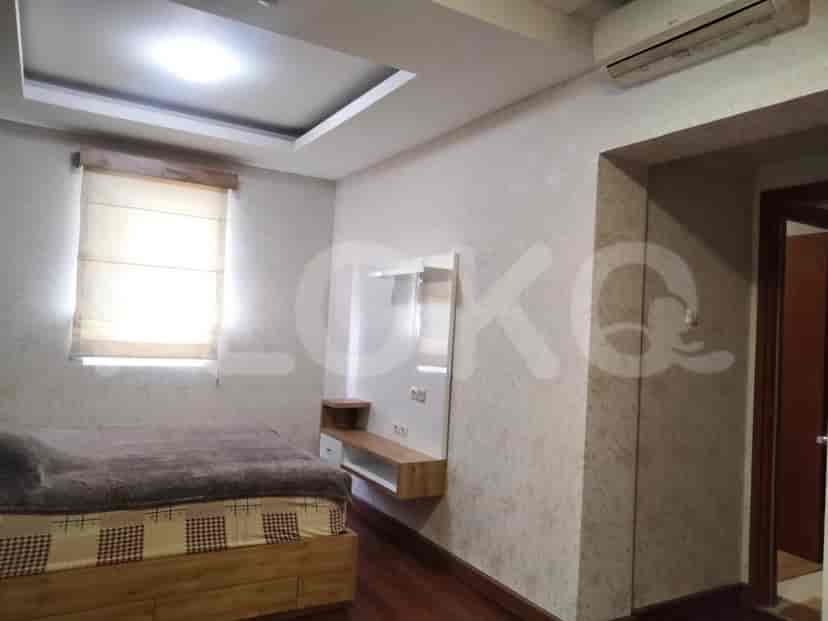 A bedroom with a bed, and a TV.