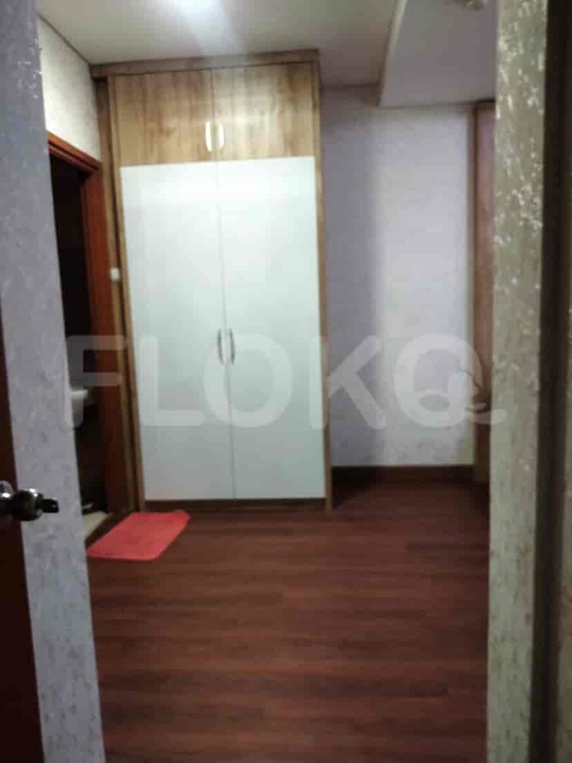 A bedroom with a white wardrobe and wooden accents.