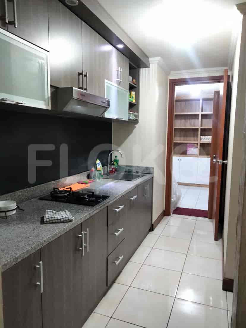 A kitchen with a countertop, stove, and cabinets.