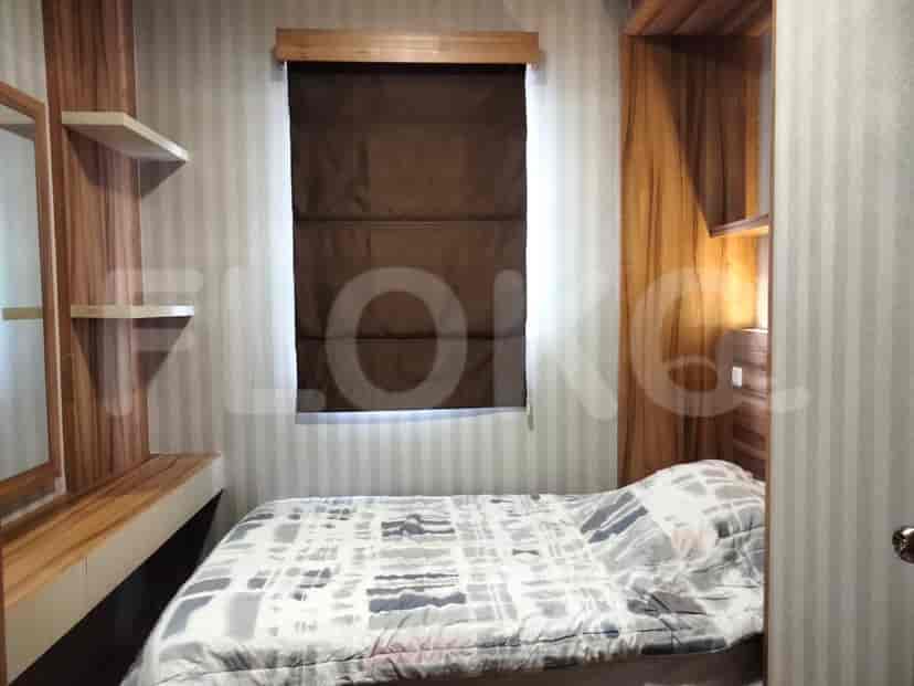 A bedroom with a bed and a wardrobe.