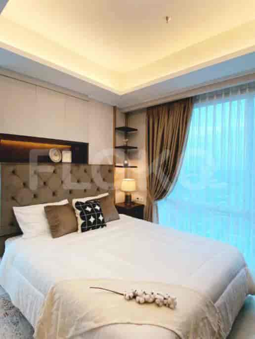 Comfortable bedroom with a large bed, headboard, and window.