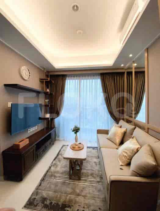 Modern living room with sofa, coffee table, and large window.