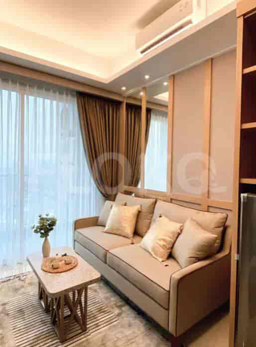 Cozy living room with sofa, mirror, and window.