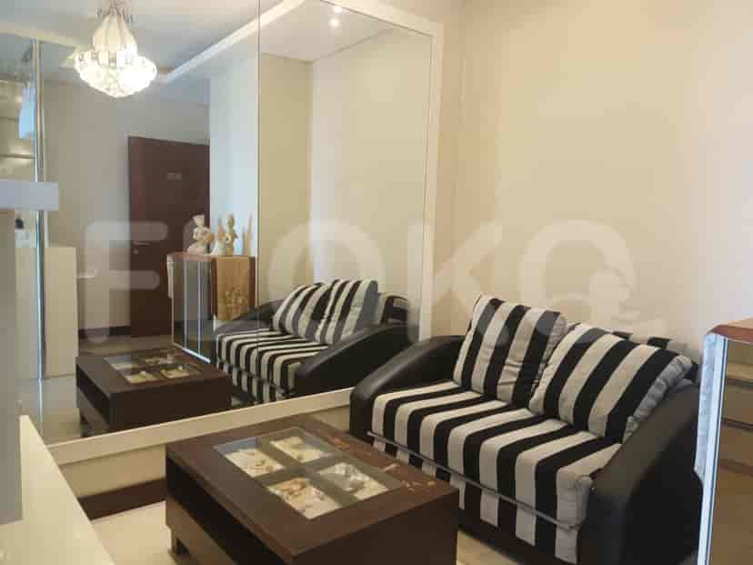 Living room with black and white striped sofa, coffee table, and large mirror.