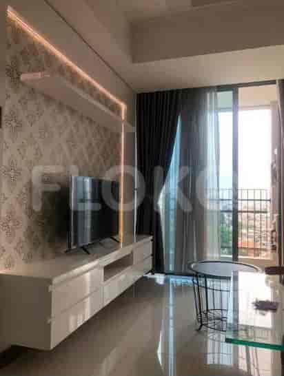 Living room with a white entertainment unit, wall-mounted TV, and balcony access.