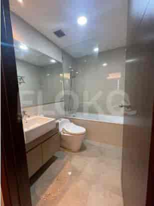 A modern bathroom with a sink, toilet, and bathtub.