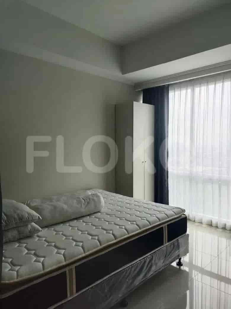 Bedroom with a bed, a closet, and large window.