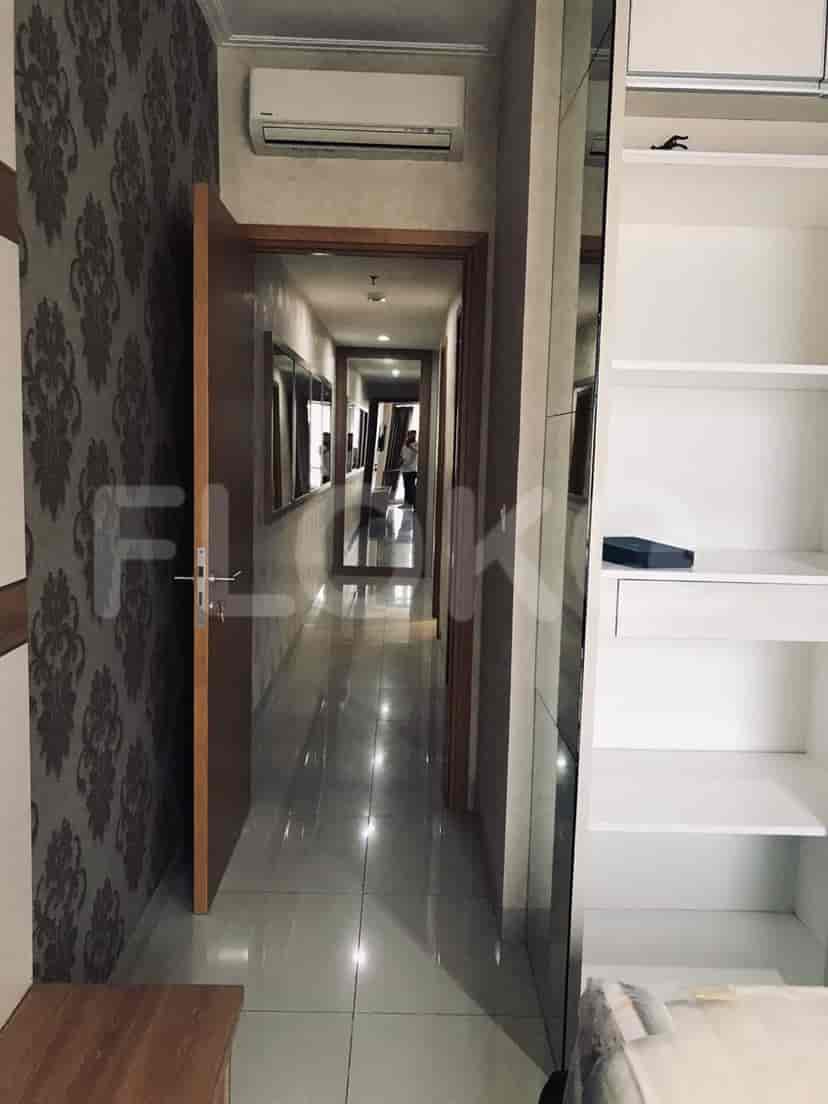 Lorong dengan dinding cermin dan pintu yang mengarah ke ruangan lain.