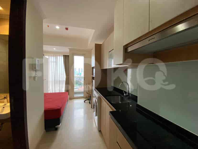 A small kitchen area with appliances and cabinets.
