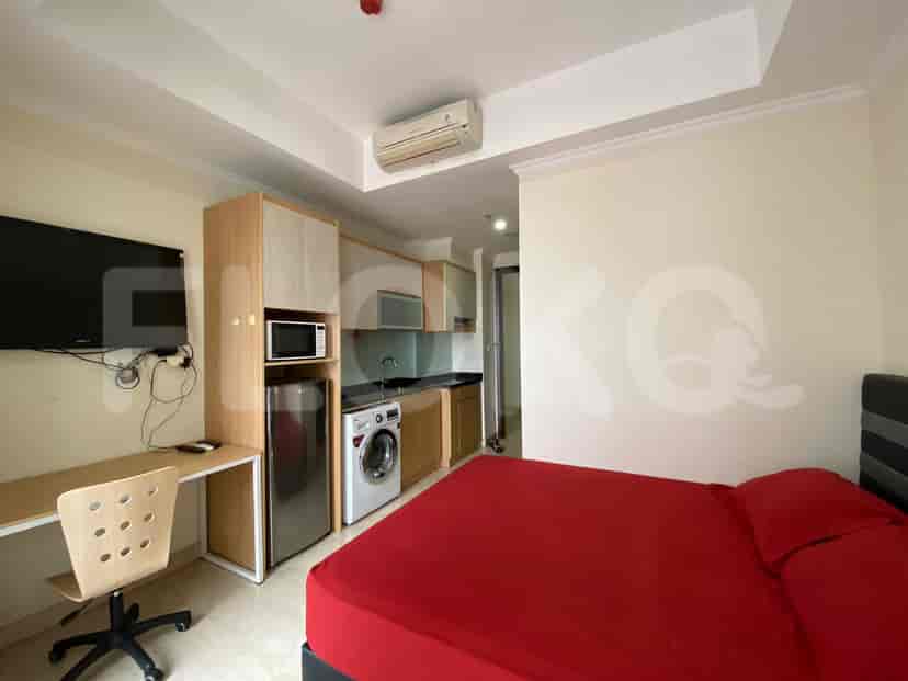 A studio apartment combining bedroom and kitchen spaces.