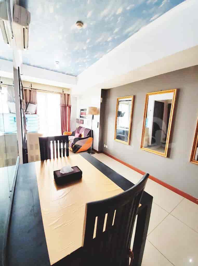 View of dining table and adjacent seating area with a sofa.