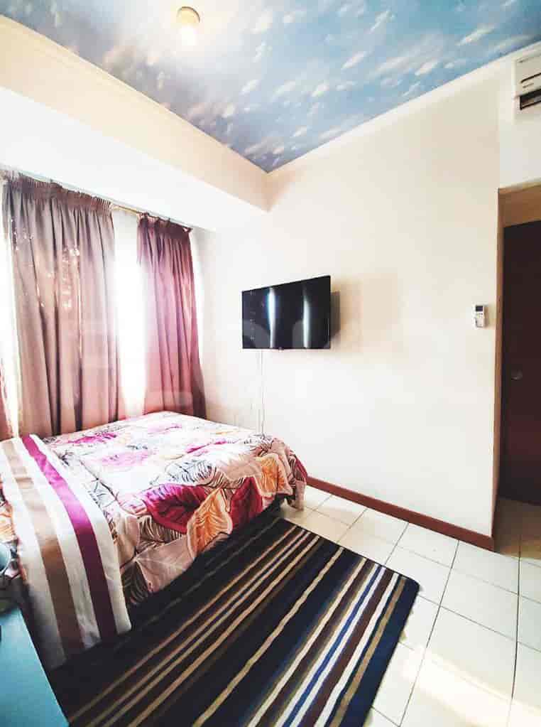 Bedroom with a double bed and a mounted TV.