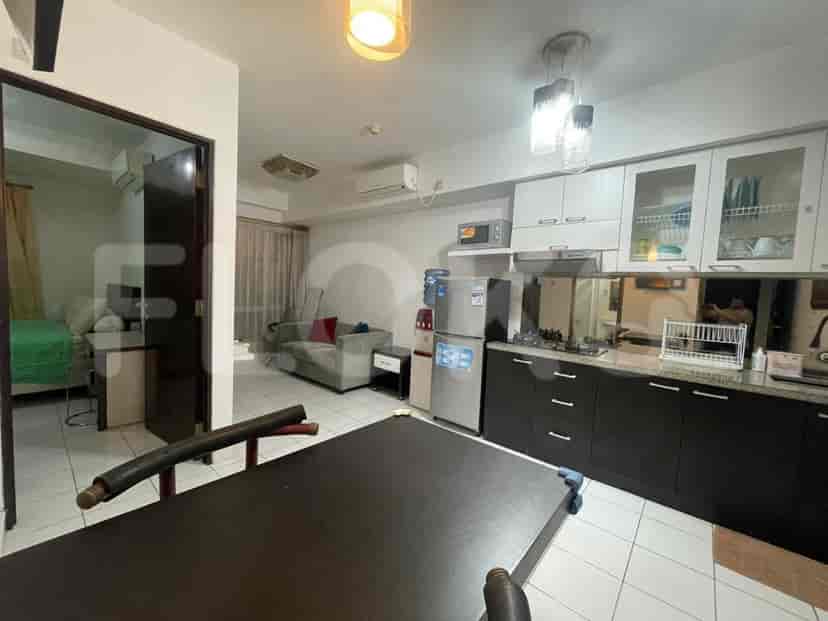 An open concept living room and kitchen with a dining table.