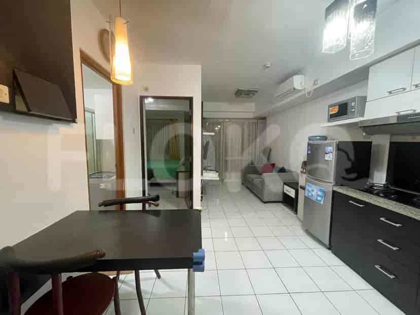 A hallway connecting the kitchen, bedroom and bathroom.