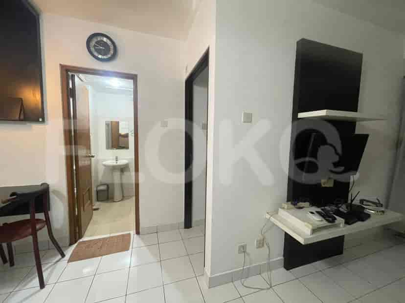 A well-equipped kitchen with a microwave, refrigerator, and gas stove.
