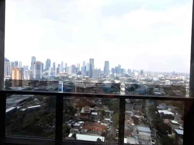 A panoramic view of a cityscape from a high-rise window.