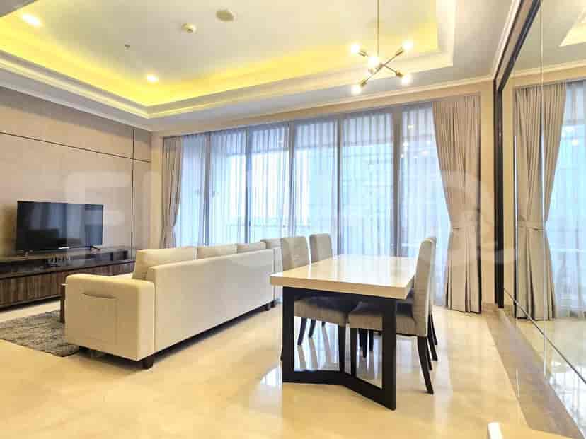 A bedroom with a bed, bedside table, and modern pendant lights, facing a large window with sheer curtains.