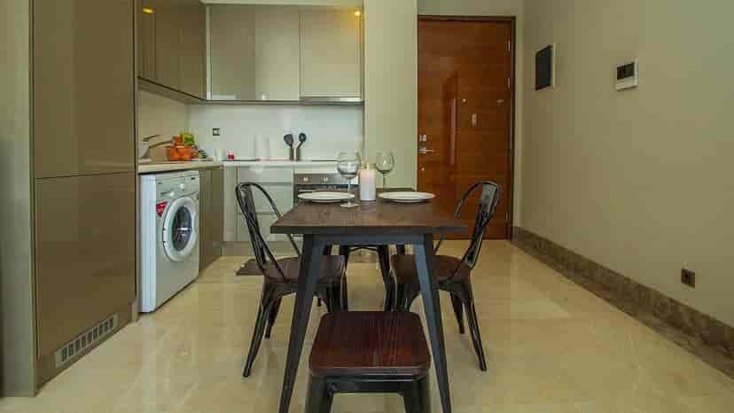 A kitchen and dining area with a table and chairs.