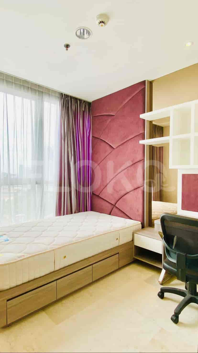 Cozy bedroom with a single bed, study table, and a large mirror.