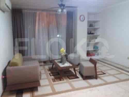 A living room featuring a seating area, shelves, and a window.