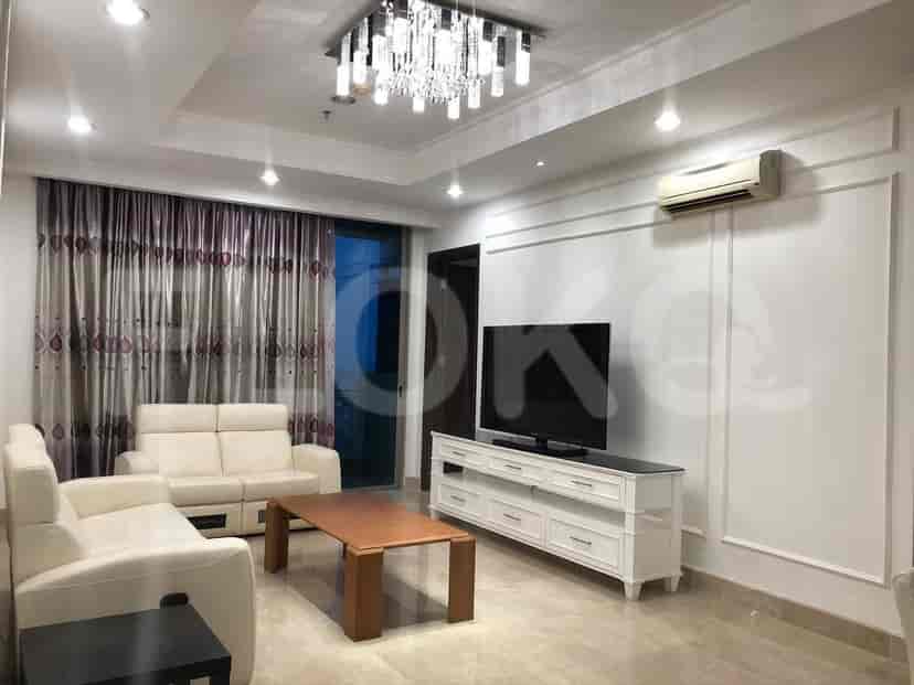 Elegant living room with white sofa, wooden coffee table, and a TV console.