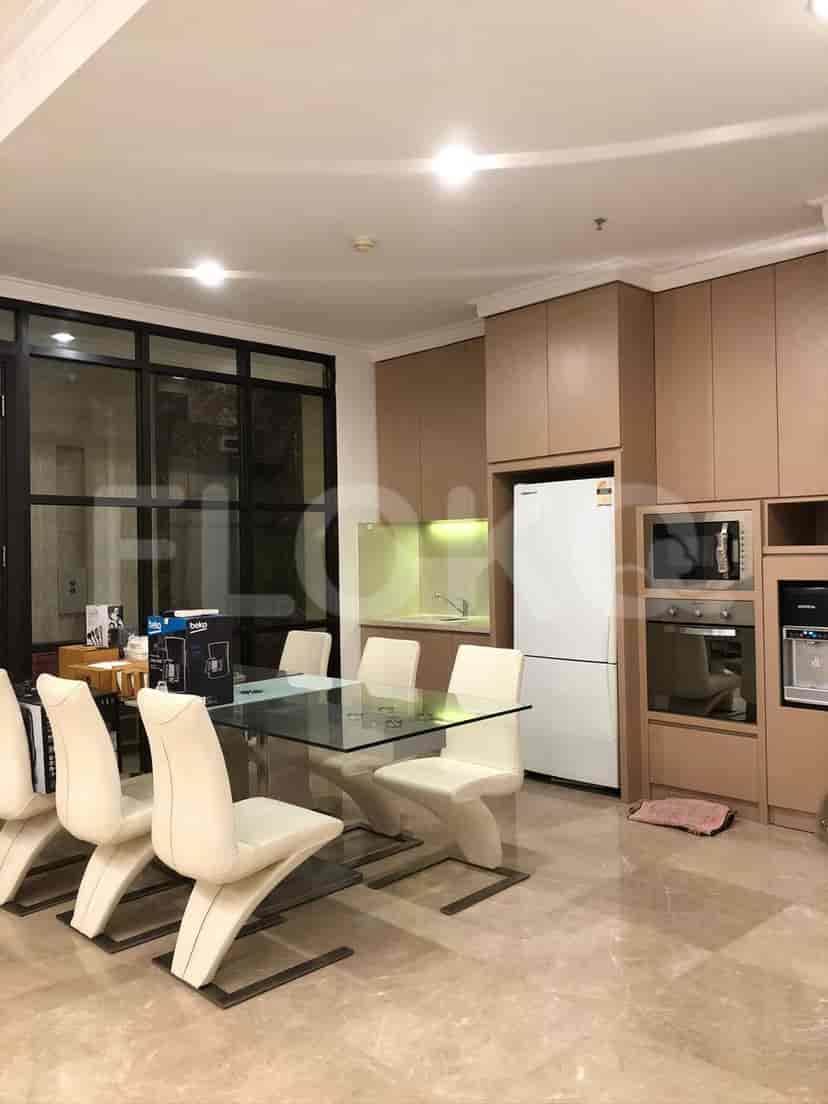 Modern kitchen and dining area with elegant furnishings.