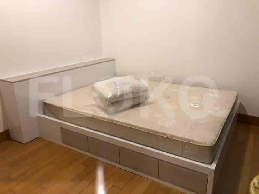 A bedroom with a bed and a neutral color scheme.