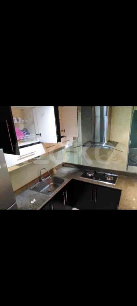 A modern kitchen with stainless steel appliances and a mirrored backsplash.