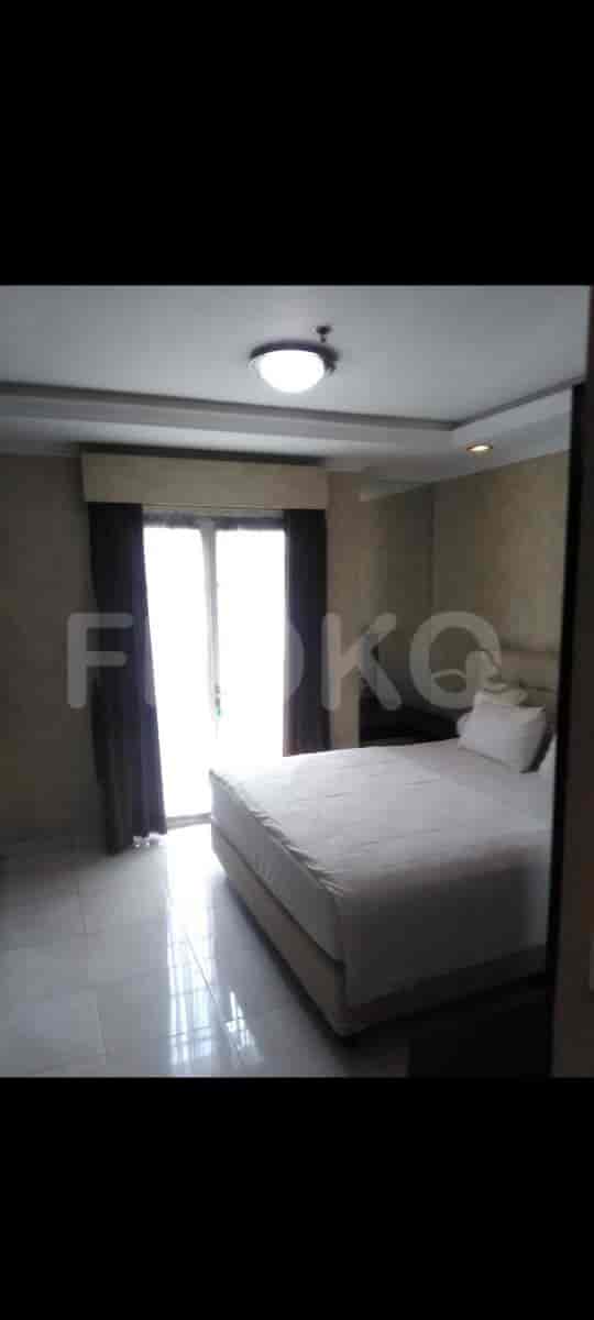 A bedroom with a bed and curtains.