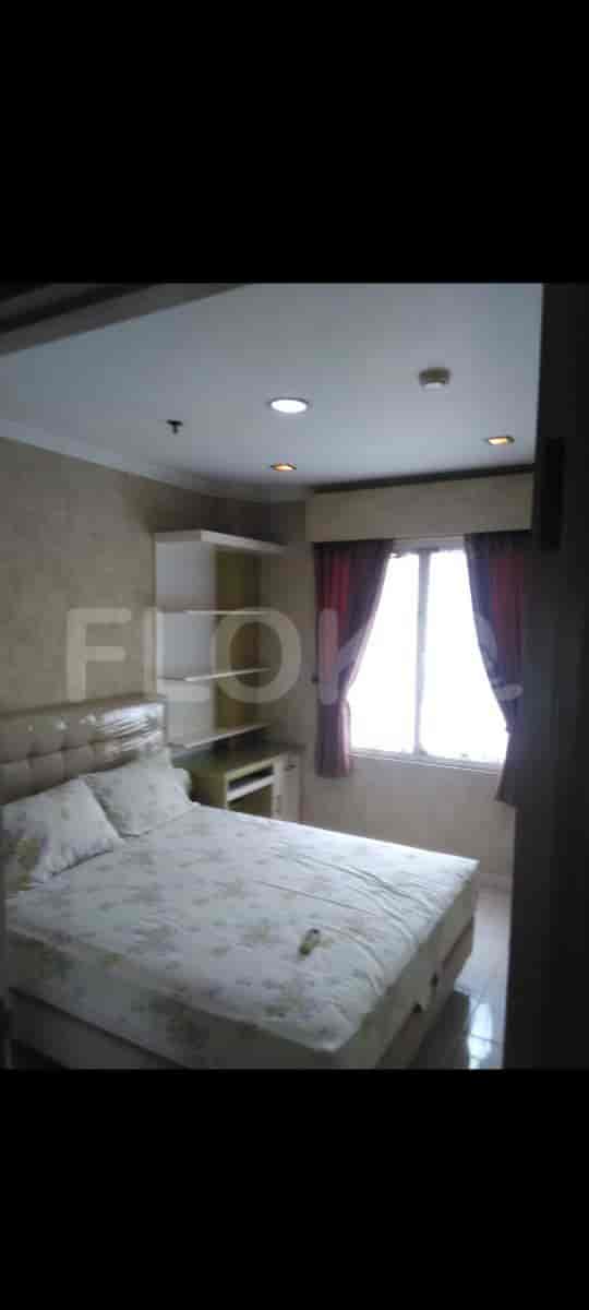 A bedroom with a bed and curtains.