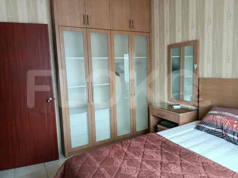 A bedroom with a wardrobe, and a bed.