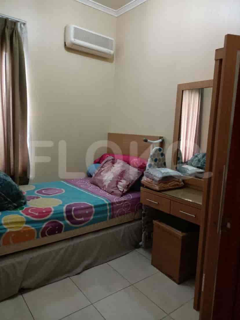 A bedroom with a bed, dresser, and an air conditioner.