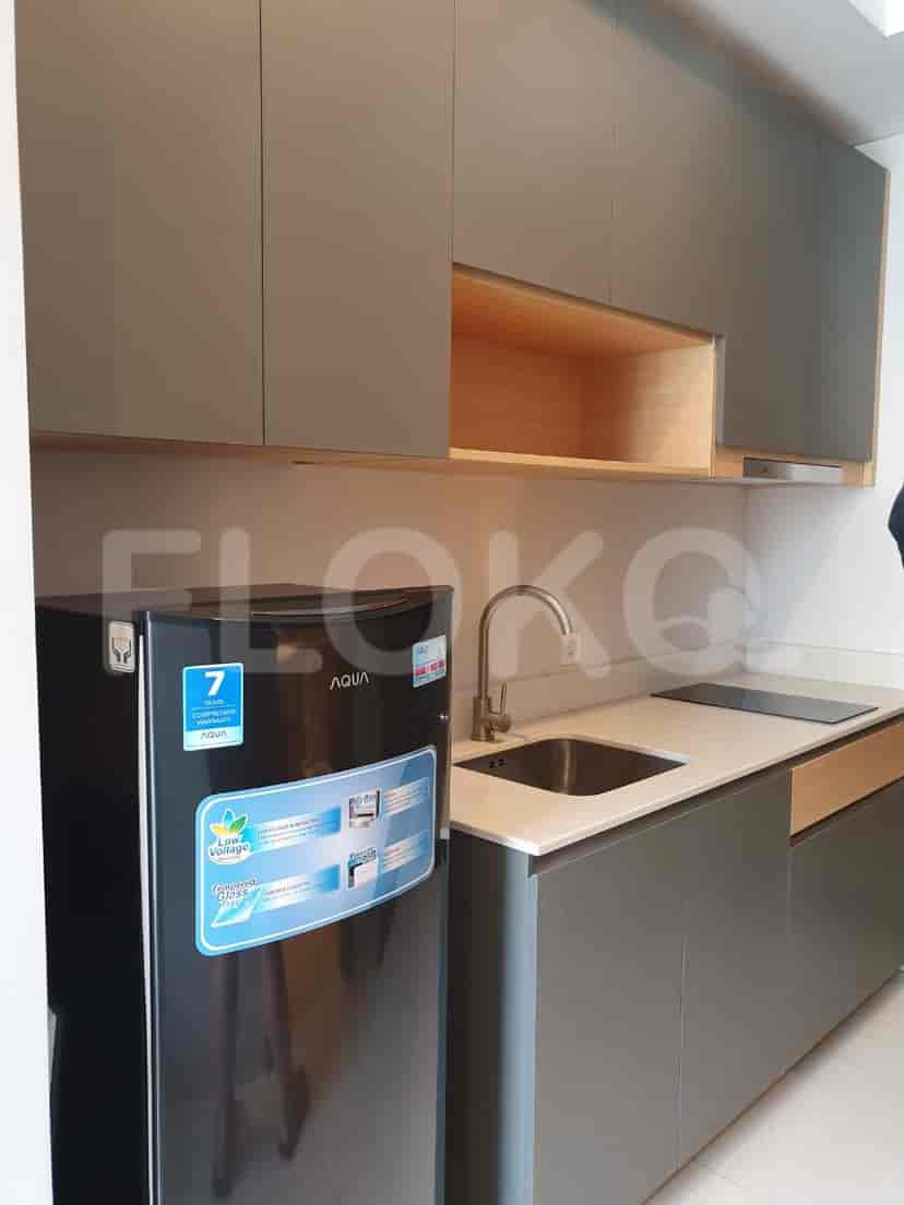 Modern kitchen with grey cabinets, an AQUA refrigerator, and an electric stove.